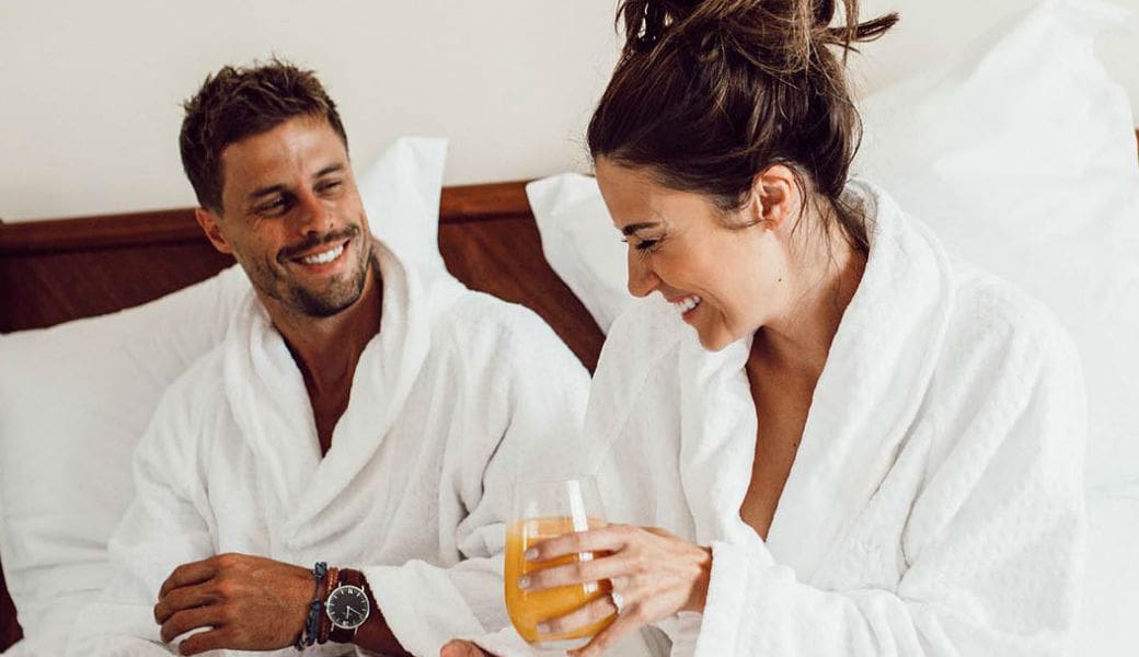 couple-in-bed-eating-breakfast-robes-m2woman - M2woman